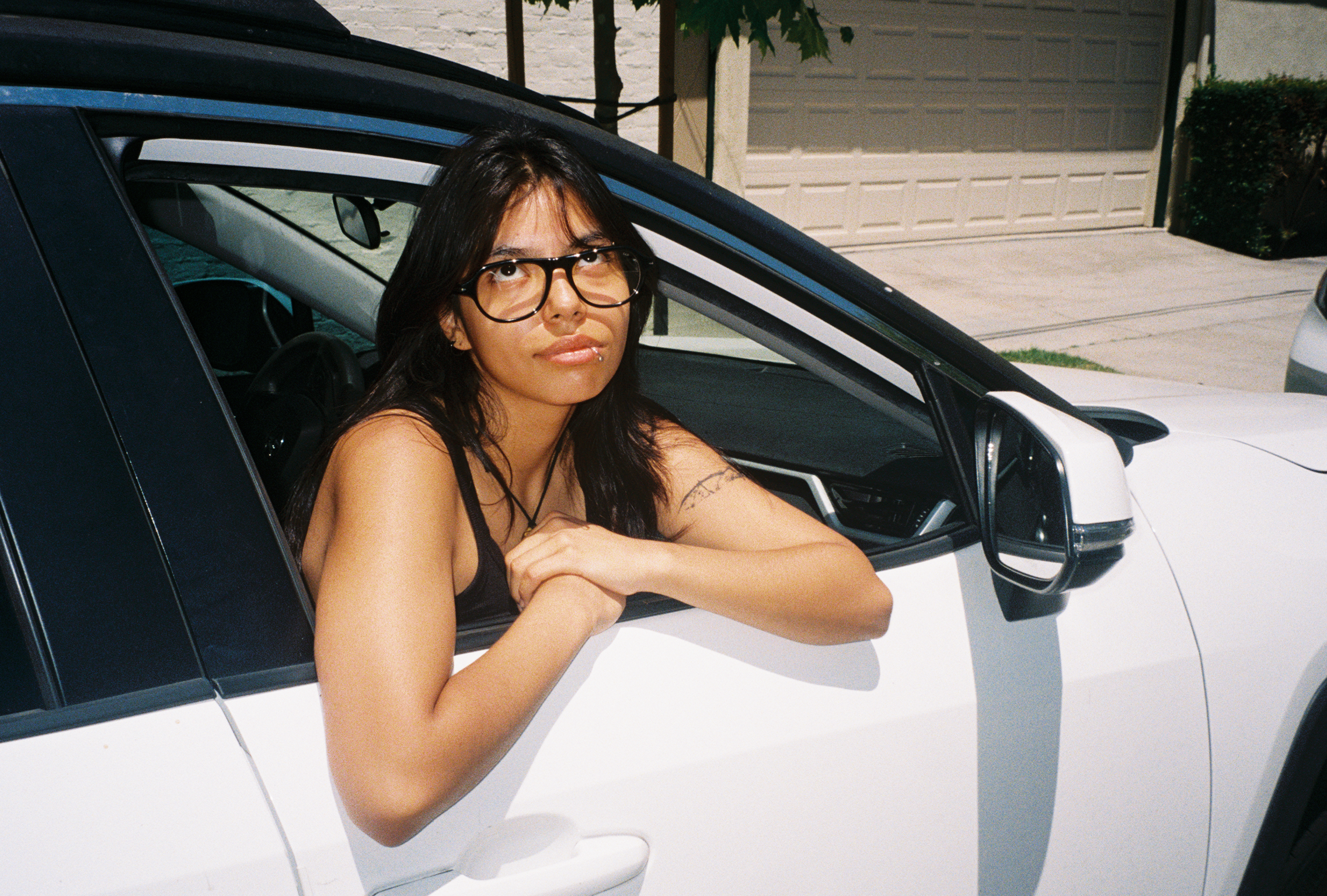 Woman wearing SAD Eyewear Ash aviator rectangle glasses in black with clear blue light blocking protection lenses