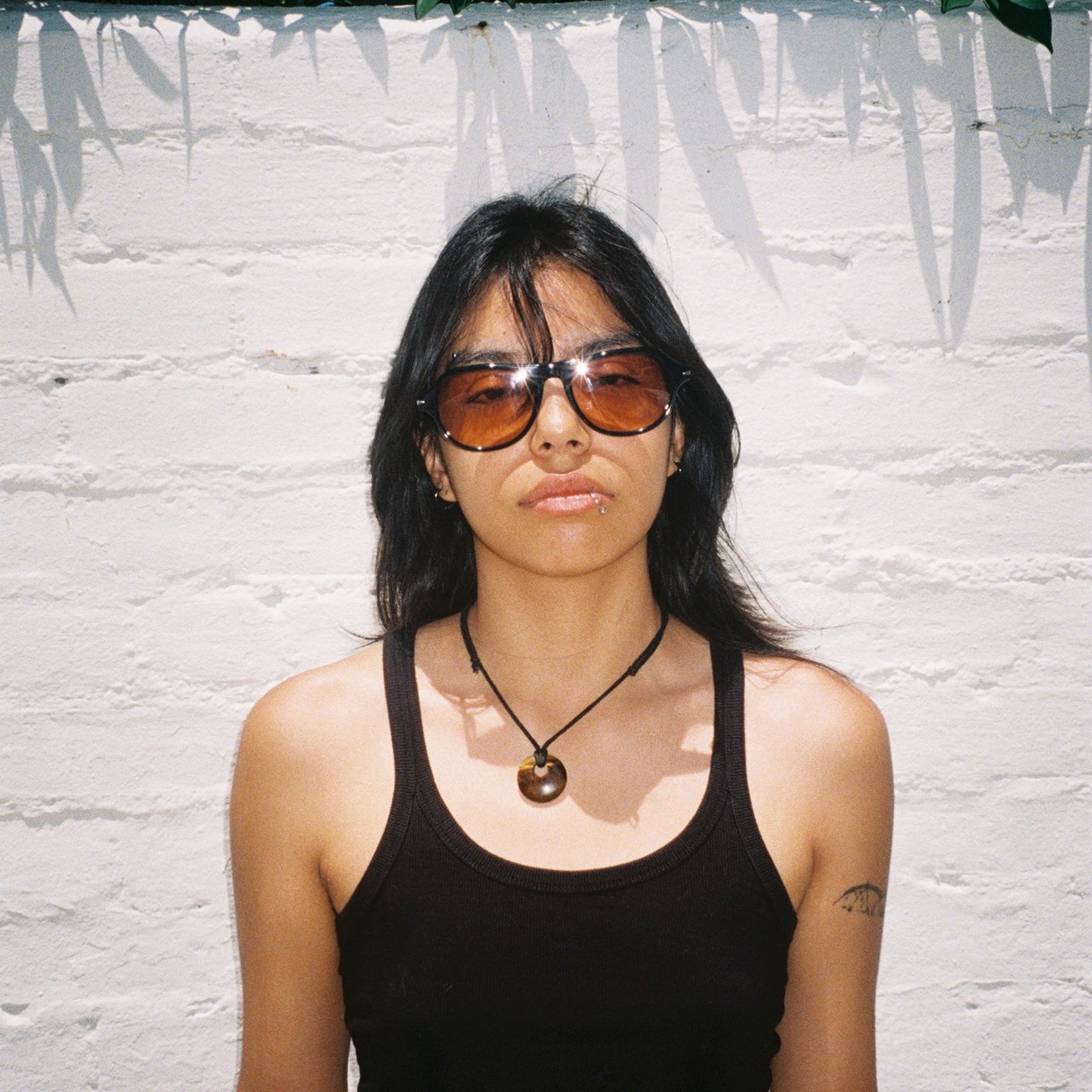 Woman wearing SAD Eyewear Ash premium square sunglasses in black with tinted bronze UV protection lenses