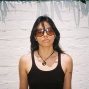 Woman wearing SAD Eyewear Ash premium square sunglasses in black with tinted bronze UV protection lenses