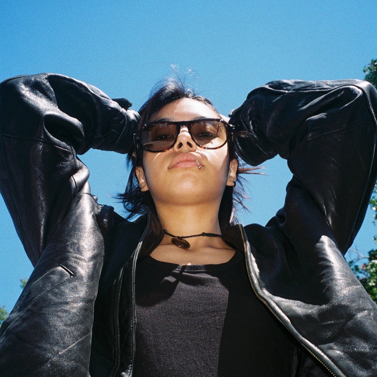 Woman wearing SAD Eyewear Ash premium square sunglasses in tortoiseshell with tinted olive UV protection lenses