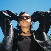 Woman wearing SAD Eyewear Ash premium square sunglasses in tortoiseshell with tinted olive UV protection lenses