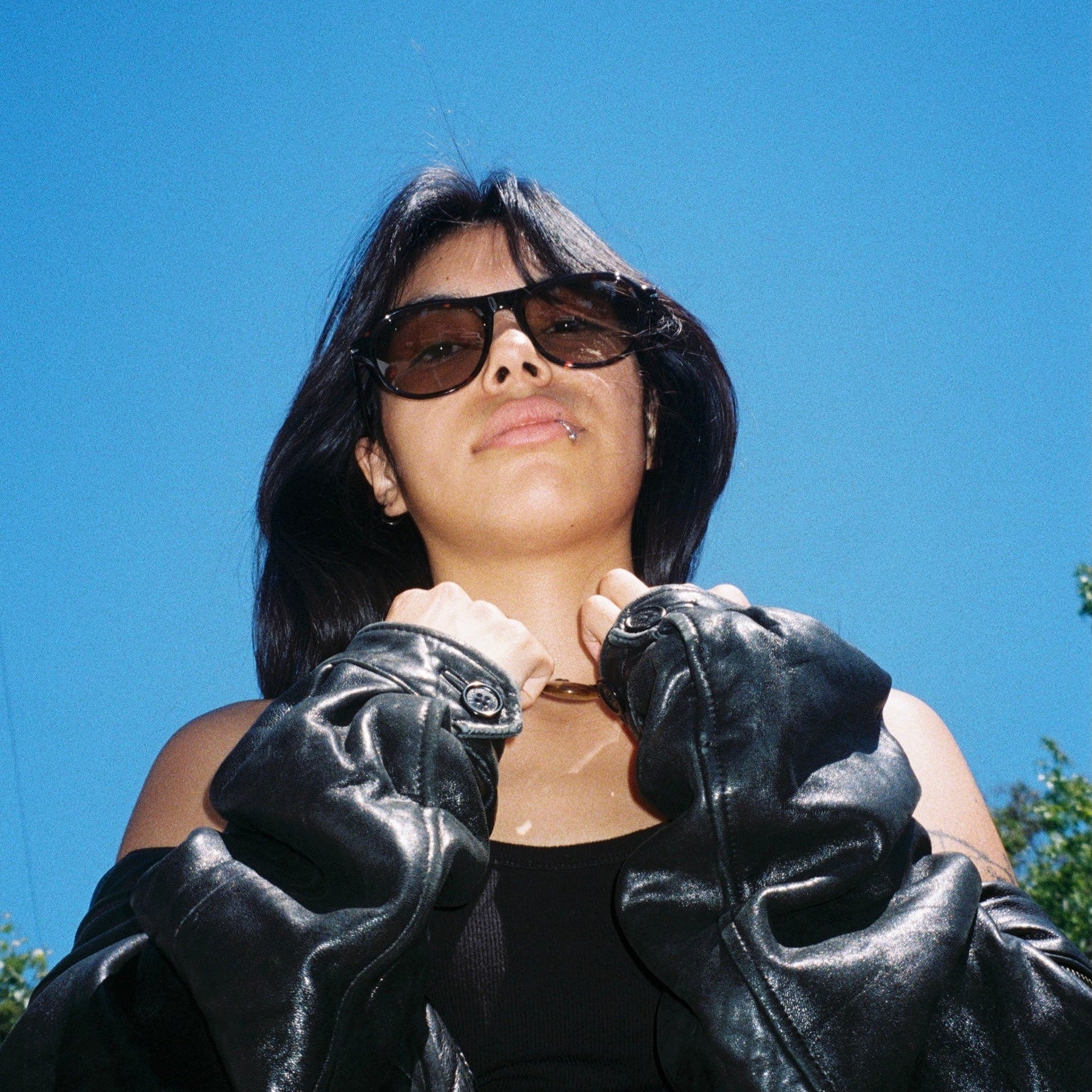 Woman wearing SAD Eyewear Ash premium square sunglasses in tortoiseshell with tinted olive UV protection lenses
