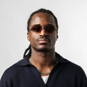Male wearing Sad Eyewear Bloom oval sunglasses in rose with UV protection lenses