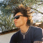 Person with sunglasses and styled hair outdoors with trees in the background. Sad Eyewear Polarized Tortoise HEAT
