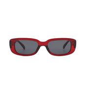 Red sunglasses with dark lenses on a white background