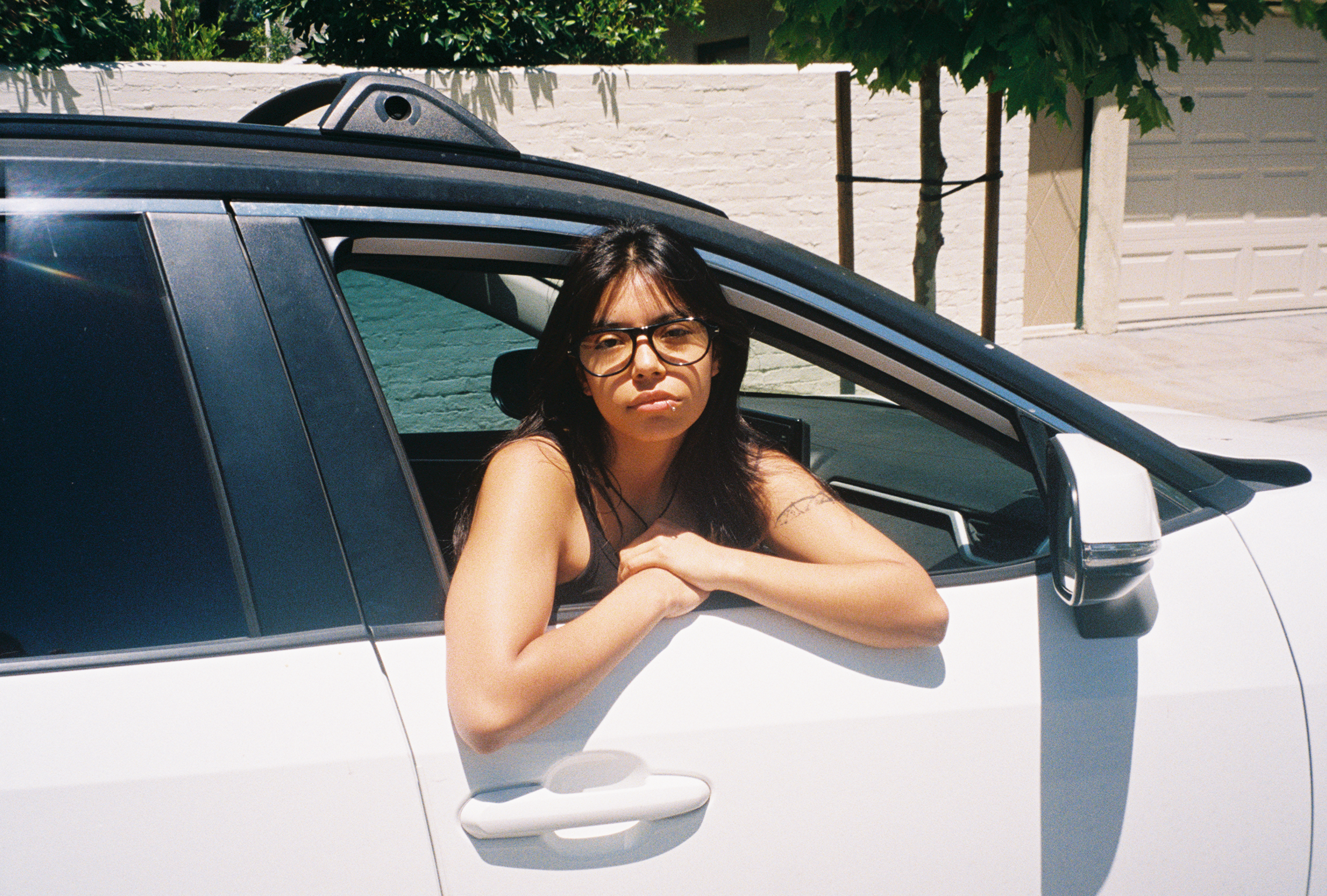 Woman wearing SAD Eyewear Ash aviator rectangle glasses in black with clear blue light blocking protection lenses