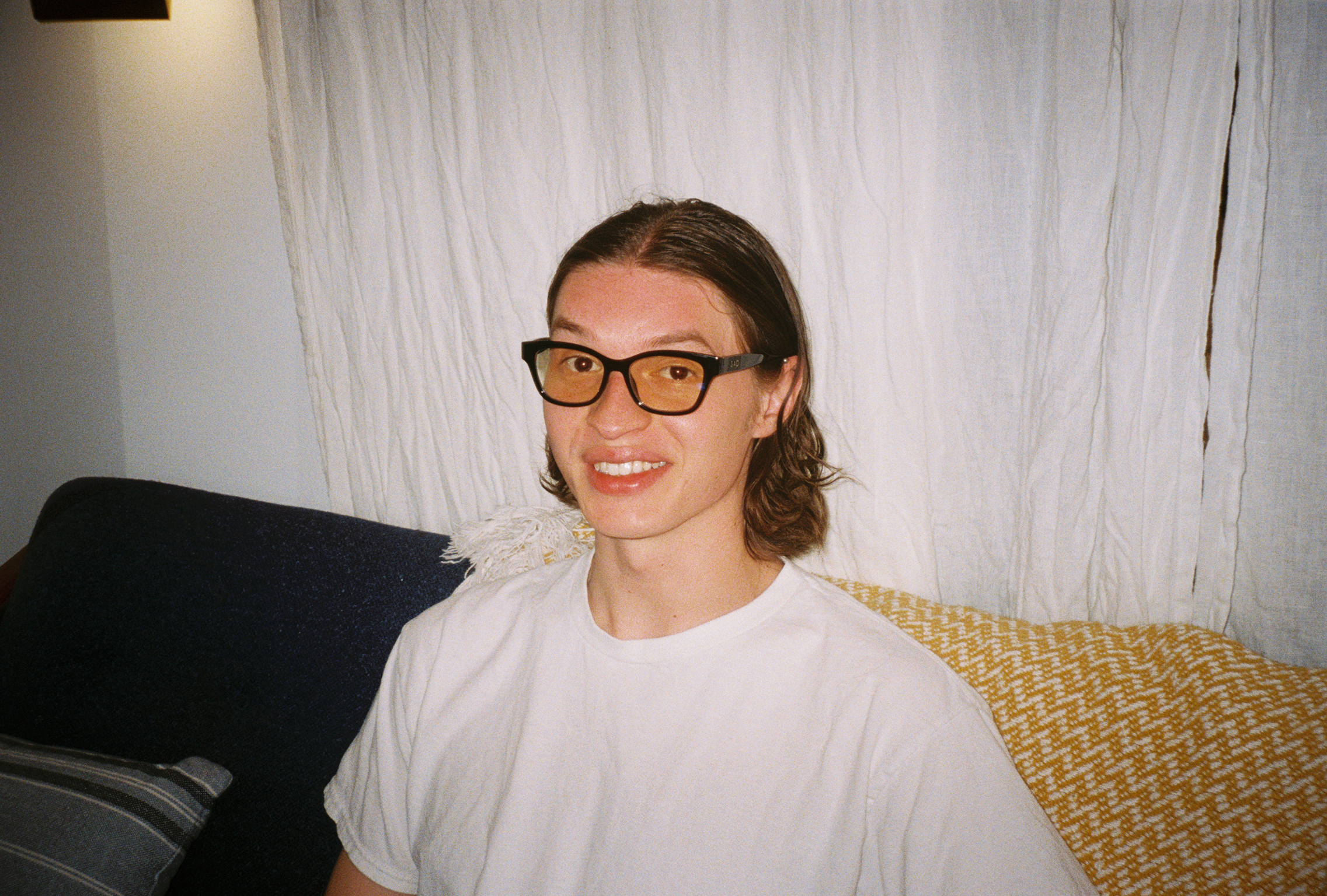 Man wearing SAD Eyewear Pony wayfarer rectangle glasses in black with clear blue light blocking protection lenses