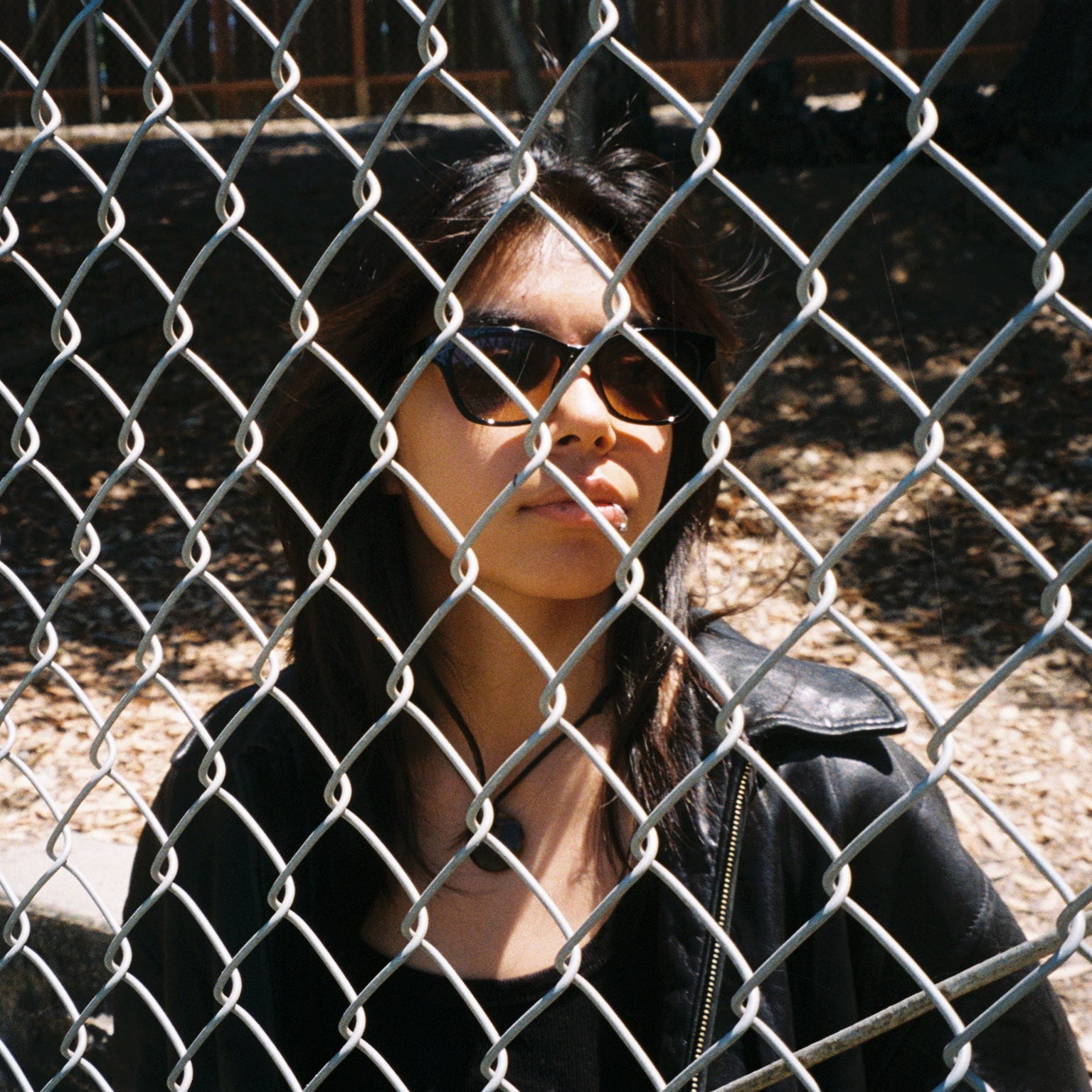 Woman wearing SAD Eyewear Pony wayfarer rectangle sunglasses in black with tinted bronze UV protection lenses