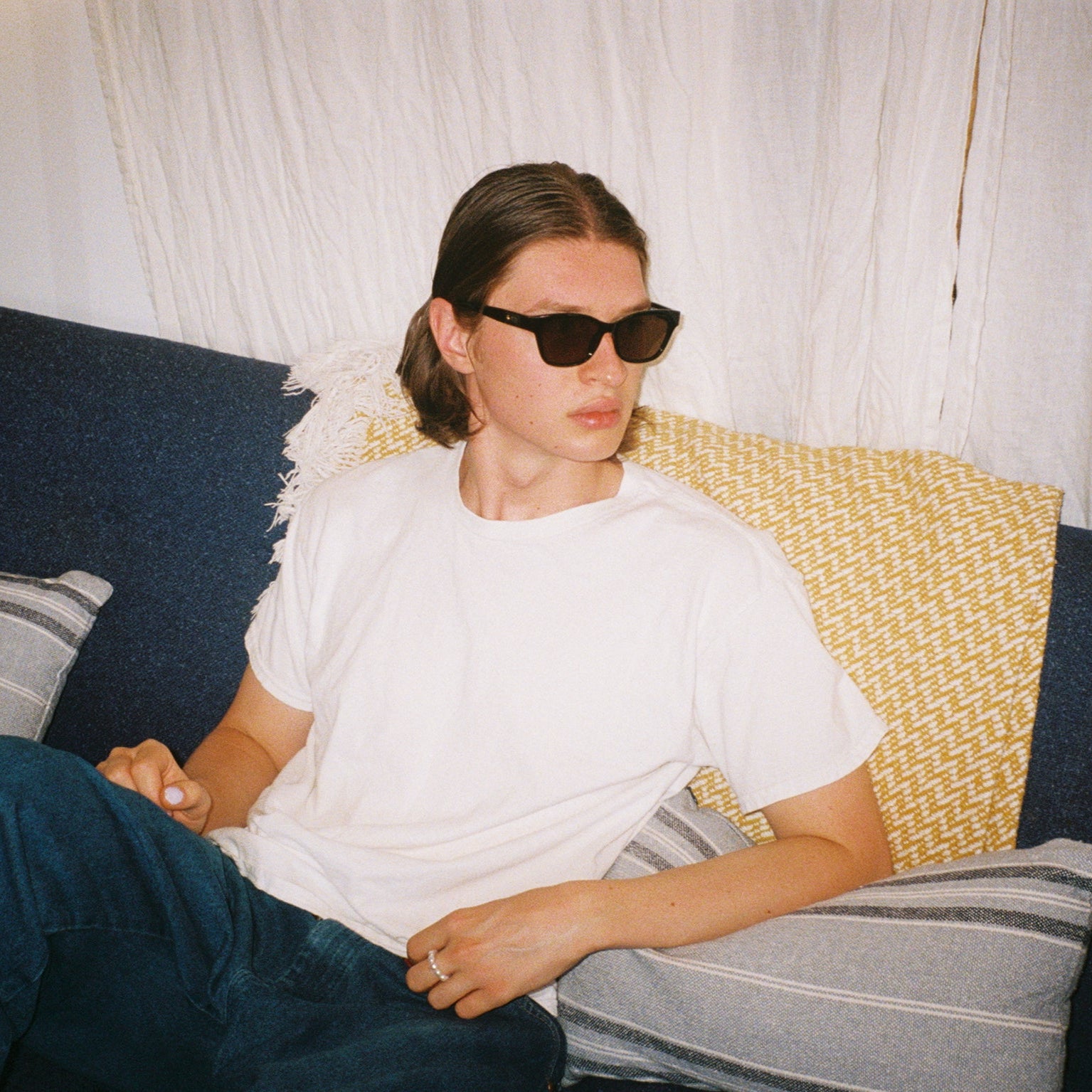 Man wearing SAD Eyewear Pony wayfarer rectangle sunglasses in black with tinted bronze UV protection lenses