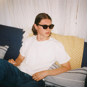 Man wearing SAD Eyewear Pony wayfarer rectangle sunglasses in black with tinted bronze UV protection lenses