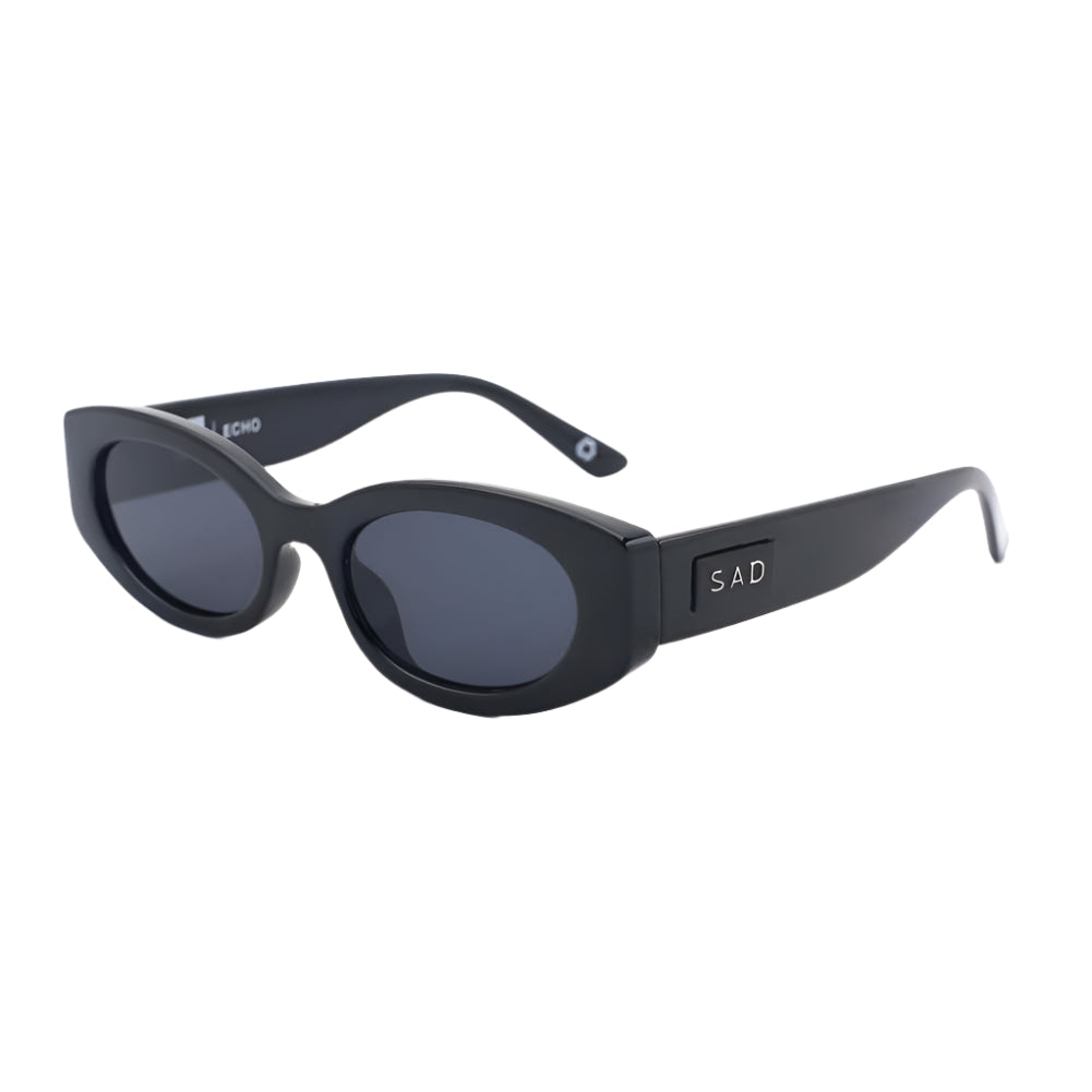 Black sunglasses with 'SAD' logo on a white background