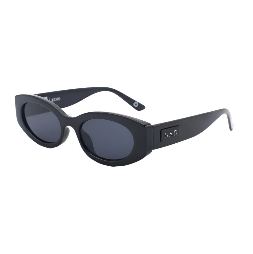 Black sunglasses with 'SAD' logo on a white background