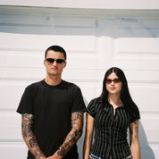 Macey Lemus and Zachary Kovacs wearing SAD Eyewear Celeste oval sunglasses in black with polarized grey UV protection lenses