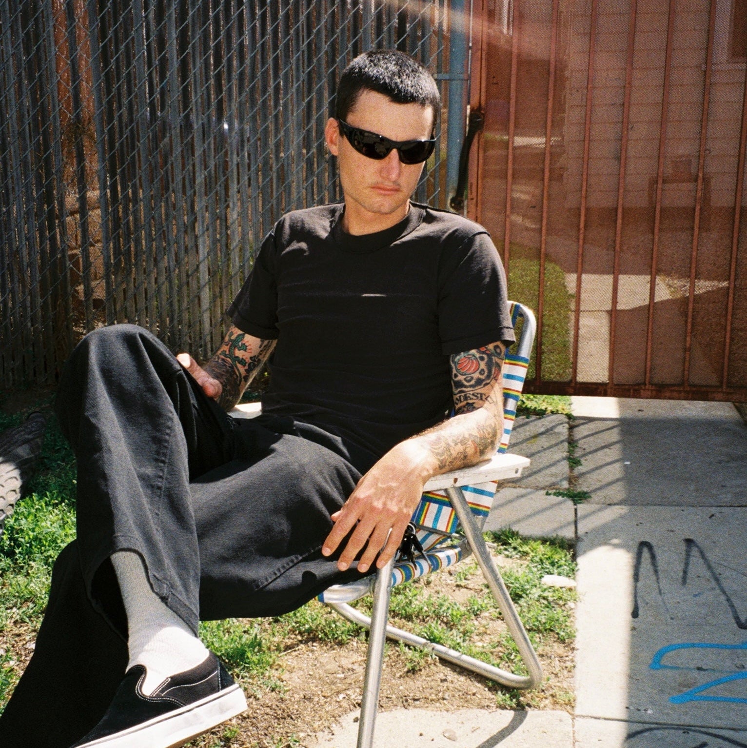Zachary Kovacs wearing SAD Eyewear Fade wrap around sunglasses in black with polarized grey UV protection lenses