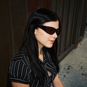 Macey Lemus wearing SAD Eyewear Fade wrap around sunglasses in black with polarized bronze UV protection lenses