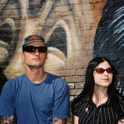 Macey Lemus and Zachary Kovacs wearing SAD Eyewear Fade wrap around sunglasses in black with polarized bronze UV protection lenses