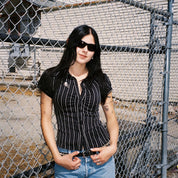 Macey Lemus wearing SAD Eyewear Fade wrap around sunglasses in black with polarized bronze UV protection lenses