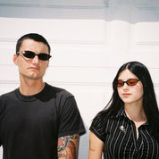 Macey Lemus and Zachary Kovacs wearing SAD Eyewear Celeste oval sunglasses in black with polarized bronze UV protection lenses