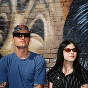 Macey Lemus and Zachary Kovacs wearing SAD Eyewear Celeste oval sunglasses in black with polarized bronze UV protection lenses