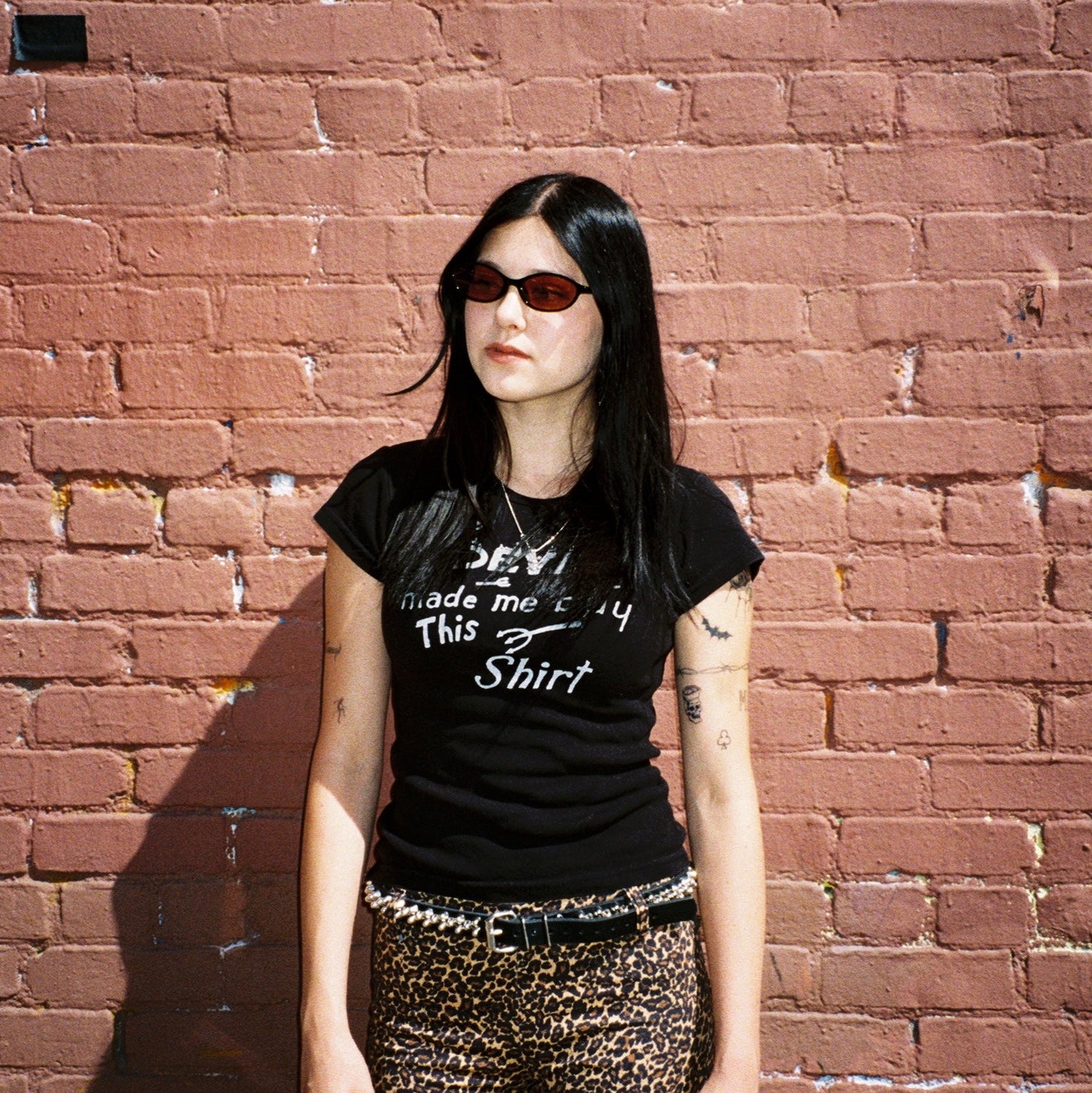 Macey Lemus wearing SAD Eyewear Celeste oval sunglasses in black with polarized bronze UV protection lenses