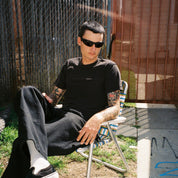 Zachary Kovacs wearing SAD Eyewear Fade wrap around sunglasses in black with polarized olive UV protection lenses