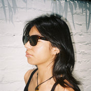 Woman wearing SAD Eyewear Pony wayfarer rectangle sunglasses in tortoiseshell with tinted olive UV protection lenses