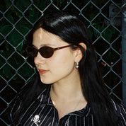 Macey Lemus wearing SAD Eyewear Celeste oval sunglasses in tobacco with polarized bronze UV protection lenses