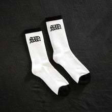 Load image into Gallery viewer, sad socks white on black backdrop
