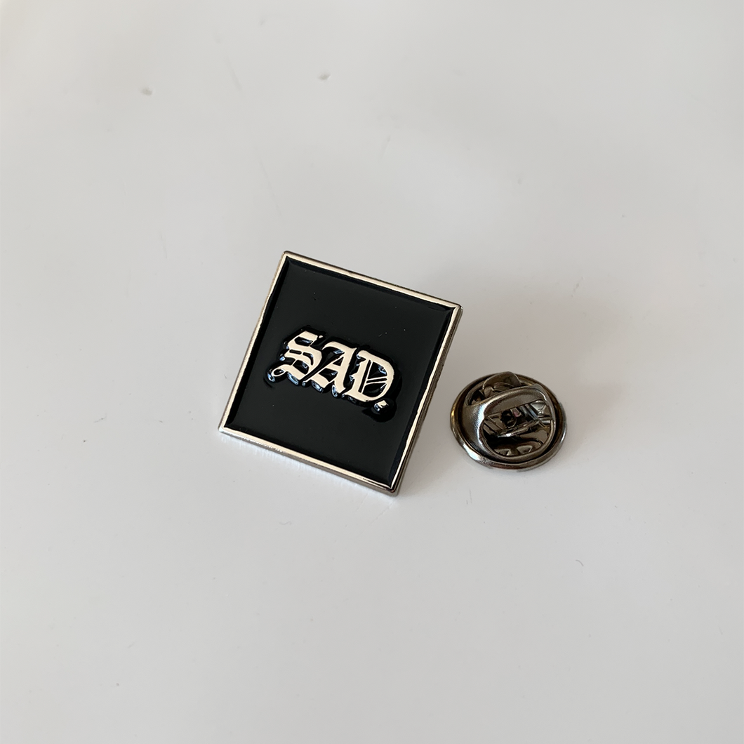 sad enamel pin 